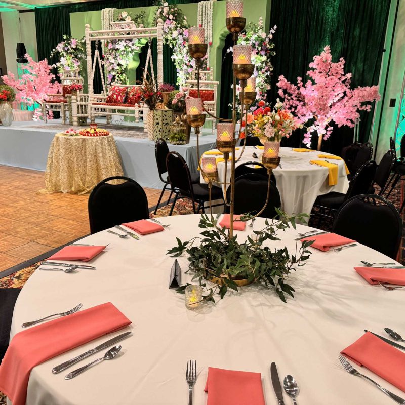 Consider The Wellington when exploring Fishers Wedding Venues Near Me image shows decorated table and stage